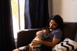 © Antonio Tanaka - young happy hispanic father hugging and holding his newborn baby