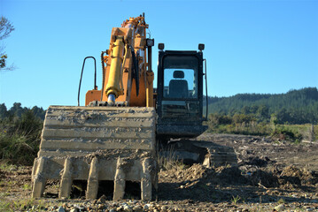 Canvas Print - Excavator growing in an agricultural field