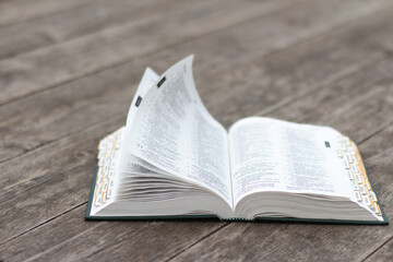 Open bible on rustic weathered wood