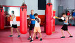 © JackF - Adult boxing instructor and happy children practicing blows on boxing bag