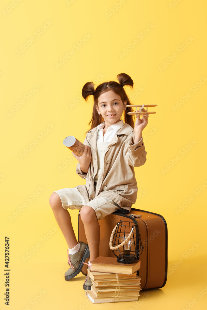 Cute little adventurer on color background