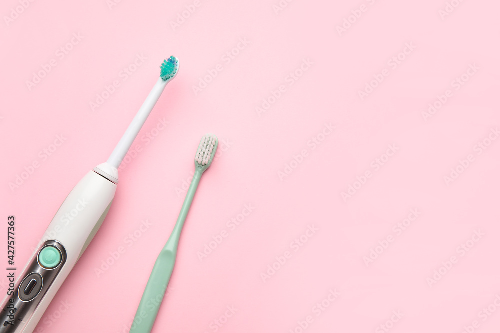 Different tooth brushes on color background