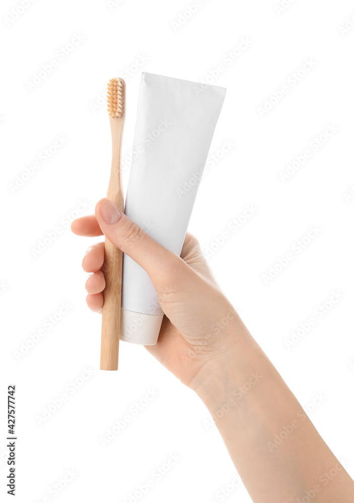 Female hand with tooth brush and paste on white background