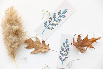 Wall Mural - Bookmarks and autumn leaves on white background