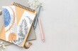 © Pixel-Shot - Notebooks with bookmarks and flowers on light background