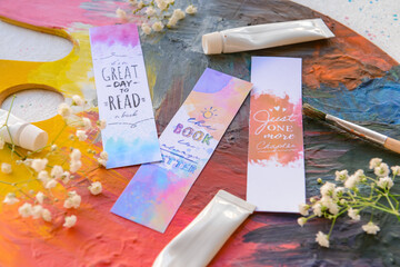 Wall Mural - Artist's supplies, bookmarks and flowers on light background, closeup