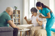 © Studio Romantic - Old retired man and woman enjoy intellectual table games together. Supportive caretaker watching couple of happy senior patients play checkers. Therapy, joy, fun leisure activities in retirement home