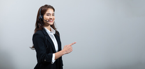 Attractive business woman in suits and headsets are smiling while working isolate on white background. Customer service assistant working in office. VOIP Helpdesk headset