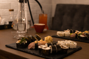 sushi assortment served on elegant black stone boards in a sushi bar