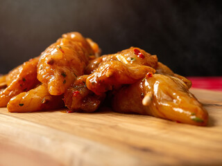 Marinated raw chicken pieces on a wooden skewer. Summer barbeque range product. Asian style sous over poultry meat. Warm smoke background. Close up. Selective focus. Seasonal food