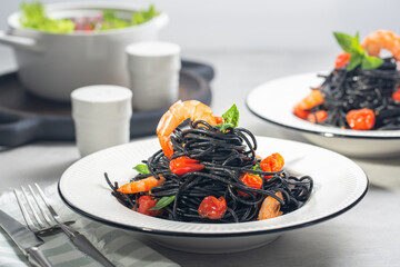 Canvas Print - Dinner with black seafood pasta. Two portions.