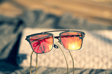 Wall Mural - Futuristic sunglasses design with big red flat lenses closeup shoot outside in a summer day . Selective focus. High quality photo