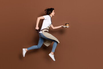 Sticker - Full size profile side photo of happy cheerful woman barista running with coffee look copyspace isolated on brown color background