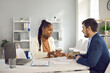 © Studio Romantic - African american woman recruiter, financial adviser, insurer giving last recommendation to employee, client, buyer before signing contract agreement in office. Business meeting, negotiation, interview