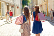 © Syda Productions - sale, consumerism and people concept - young women with shopping bags walking along city street