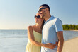 © Syda Productions - leisure, relationships and people concept - happy couple in sunglasses hugging on summer beach