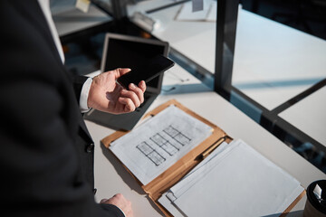 Wall Mural - Businessman using modern mobile phone in office