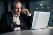 © Svitlana - Joyful man in headphones using laptop at work