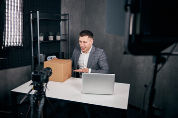 Cheerful young man recording video for blog