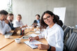 © Prostock-studio - Businesswoman Taking Notes Smiling To Camera At Corporate Meeting Indoor