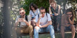© guruXOX - Group of friends using smartphones together. Young people addiction to new technology trends. Youth, new generation internet friendship concept. Emotional isolation and depresion