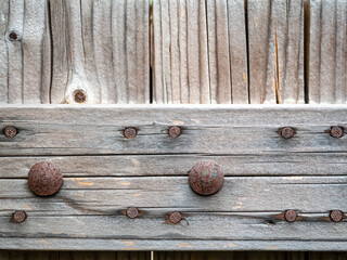 Close up textured old wooden door detail with rusted steel bolts in loft style,detail for loft design