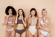 © LIGHTFIELD STUDIOS - interracial women in underwear touching faces and fixing hair on beige