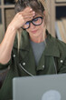 © simona - Stressed and tired adult woman at work at home with online laptop computer in smart working modern activity - people think for hard work needing relax - stress  lifestyle for online life and internet