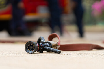 Poster - Red Fire hose And high pressure water jets nozzle on the floor