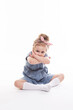 © BestForYou - Childhood, emotions concept, little cute girl in a blue dress posing in the studio on a white