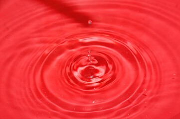 water droplet in a red bowl