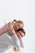 © LIGHTFIELD STUDIOS - happy father and daughter smiling at camera while having fun at home