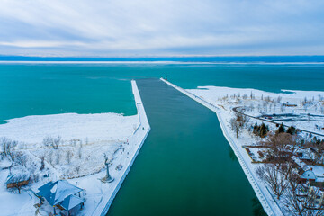 Icy Great Lakes Lighthouse and Pier at St. Joseph, Michigan Aerial View. Beautiful Lake Michigan Water views. 