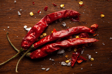 Wall Mural - Macro close-up of Organic red chili pepper( Capsicum annuum)  on wooden top background. Pile of Indian Aromatic Spice. Top view