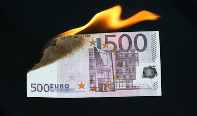 Five hundred Euros are burning with fire isolated on black