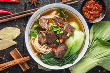 Spicy Red Soup Beef Noodle In A Bowl On Wooden Table
