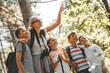 © BalanceFormCreative - Group of children hiking in forest with they teacher.They learning about nature and wildlife.