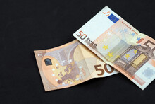 new and old 50 euro banknotes stand on black background,