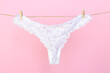 Female white sexy lace panties hanging on clothesline