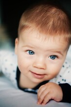 Close-up Portrait Of Cute Baby With Blue Eyes
