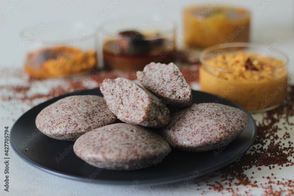 Steamed cakes made with finger millets and skinned black gram. Locally ...