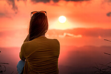 Silhouette of woman watching beautiful sunset