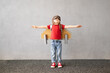 © Sunny studio - Happy child playing with toy paper rocket