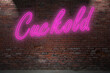 Neon Cuckold lettering on Brick Wall at night