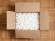 © Adrian - A cardboard box with packing styro foam pellets top view