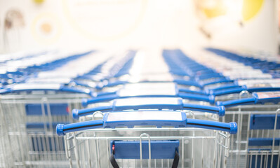 Many big metal shopping carts for the interior furniture on a parking lot for the customer use shopping in the warehouse store.