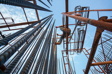 (Selective focus) Construction workers working on structural deformed steel buildings.