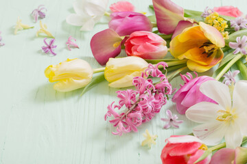 spring flowers on green wooden background