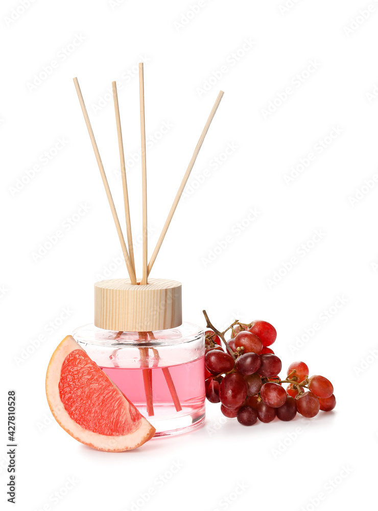 Reed diffuser with grape and grapefruit on white background