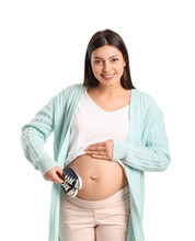 Young Pregnant Woman With Baby Booties On White Background